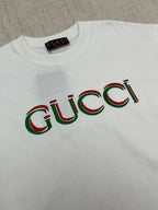 White Gucci T-shirt with multicolor Gucci logo print across the chest