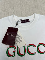 White Gucci T-shirt with large multicolor Gucci logo graphic near the neckline