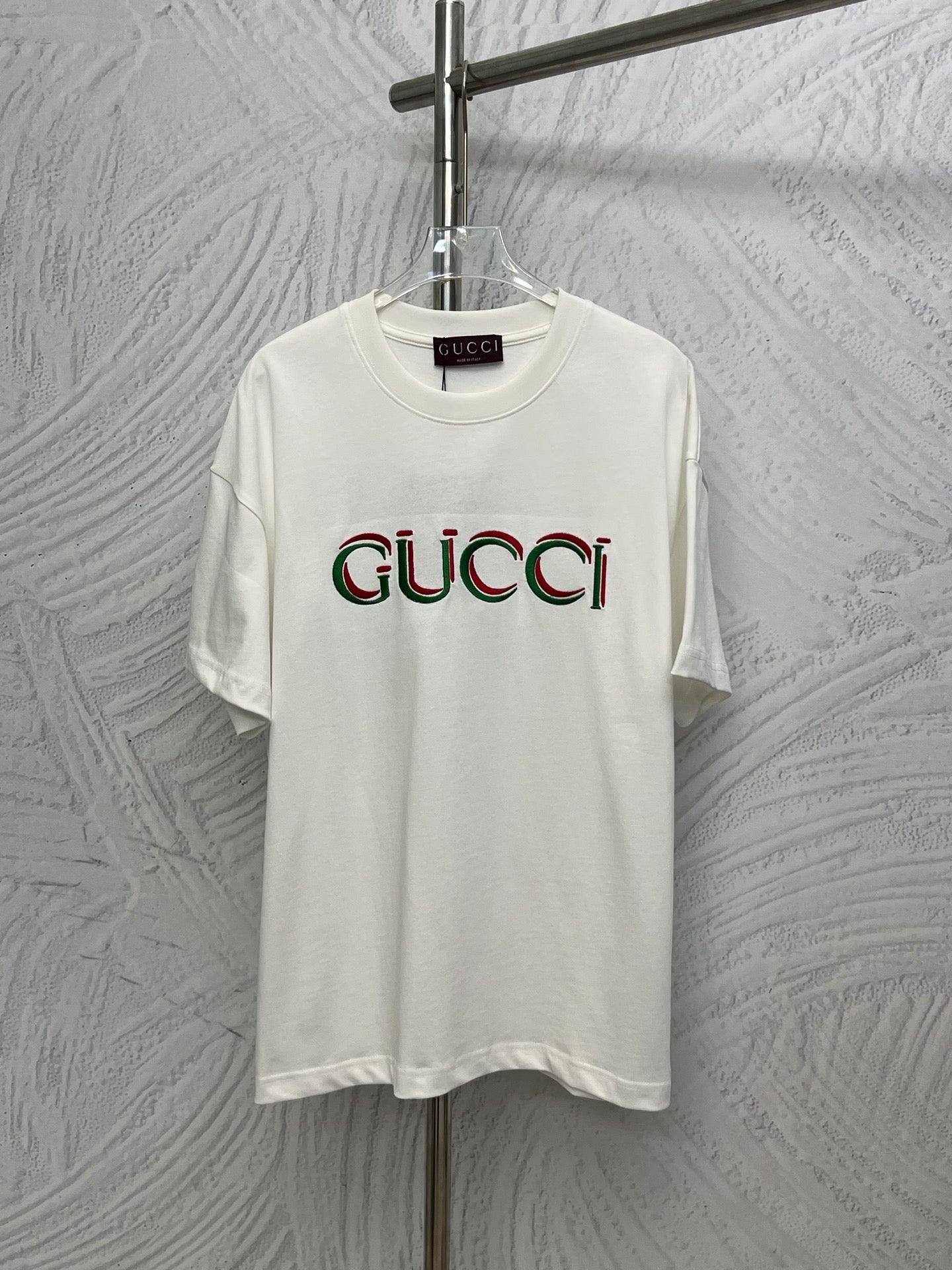 White Gucci T-shirt with multicolor Gucci logo print on the chest