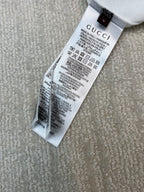 Gucci care label on white T-shirt hem, with washing instructions