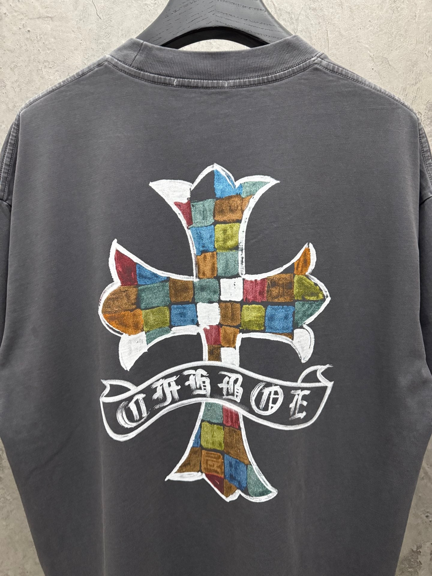 Dark gray short-sleeve T-shirt with large multicolor cross logo on back