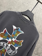 Dark gray short-sleeve T-shirt shoulder close-up with multicolor cross graphic and text