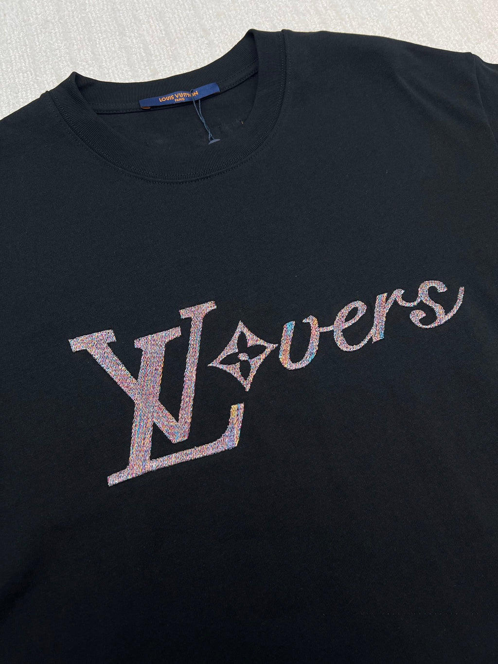 Louis Vuitton black T-shirt close-up of multicolor LV logo