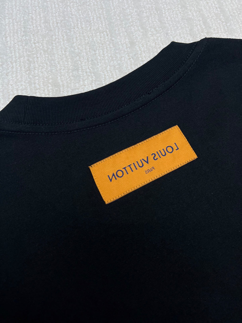 Louis Vuitton black T-shirt with orange size label at the collar