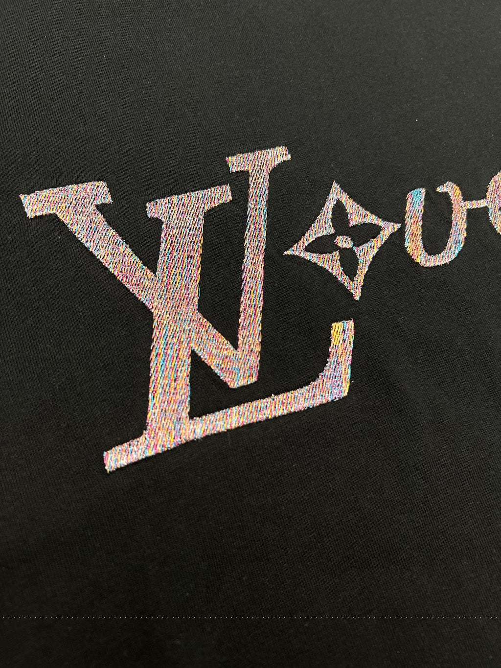 Louis Vuitton black T-shirt logo close-up with textured letters
