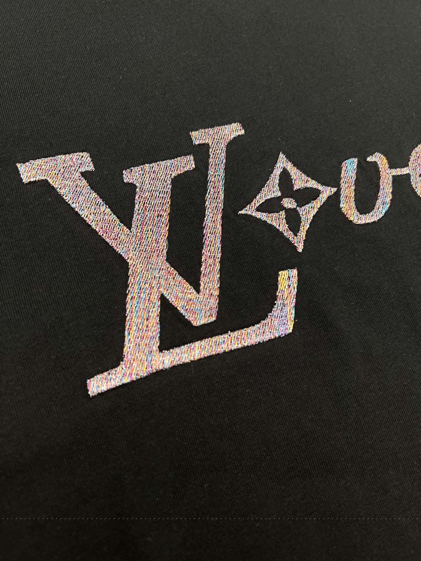 Louis Vuitton black T-shirt logo close-up with textured letters