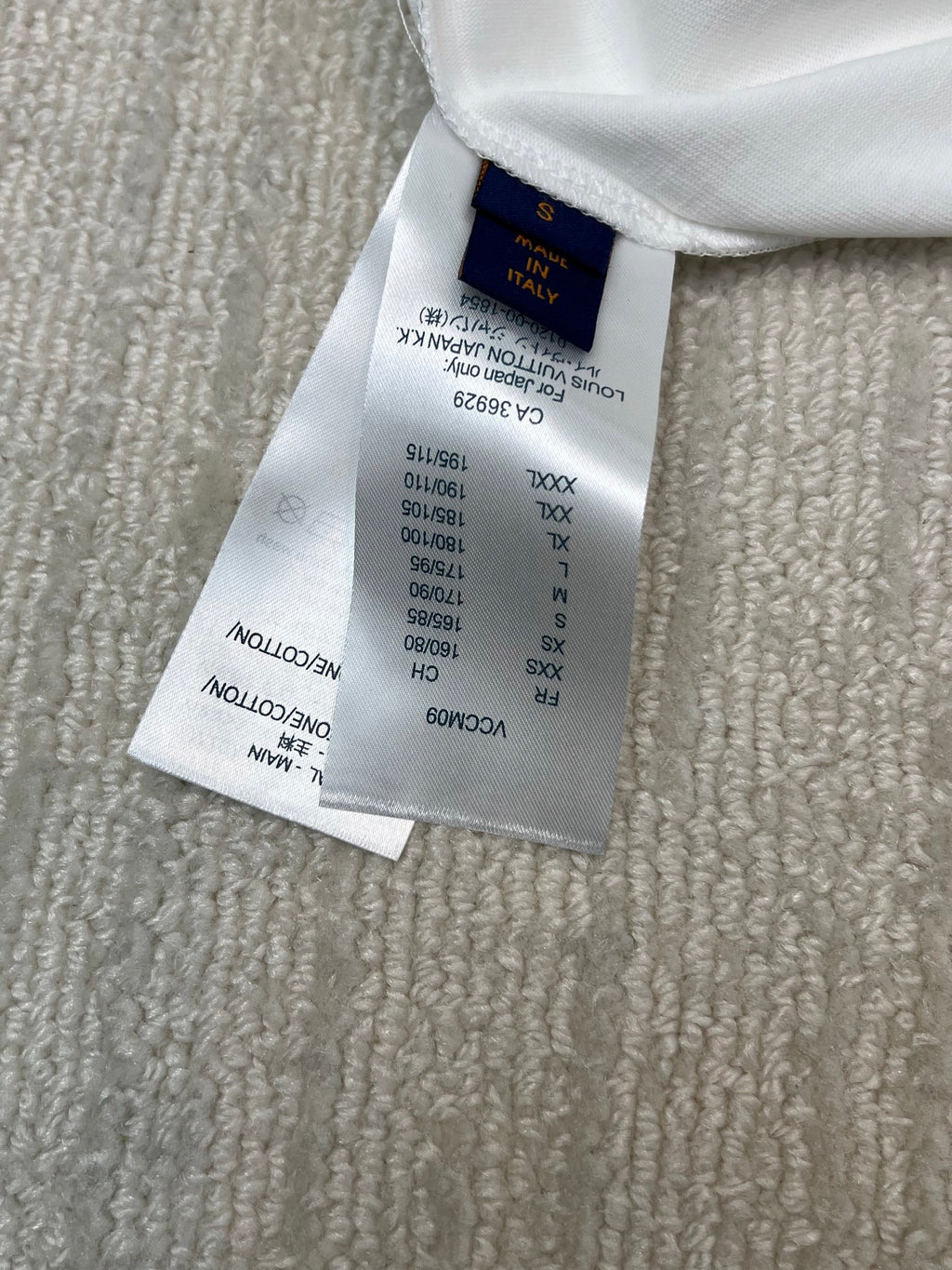 White T-shirt care label with size and fabric information