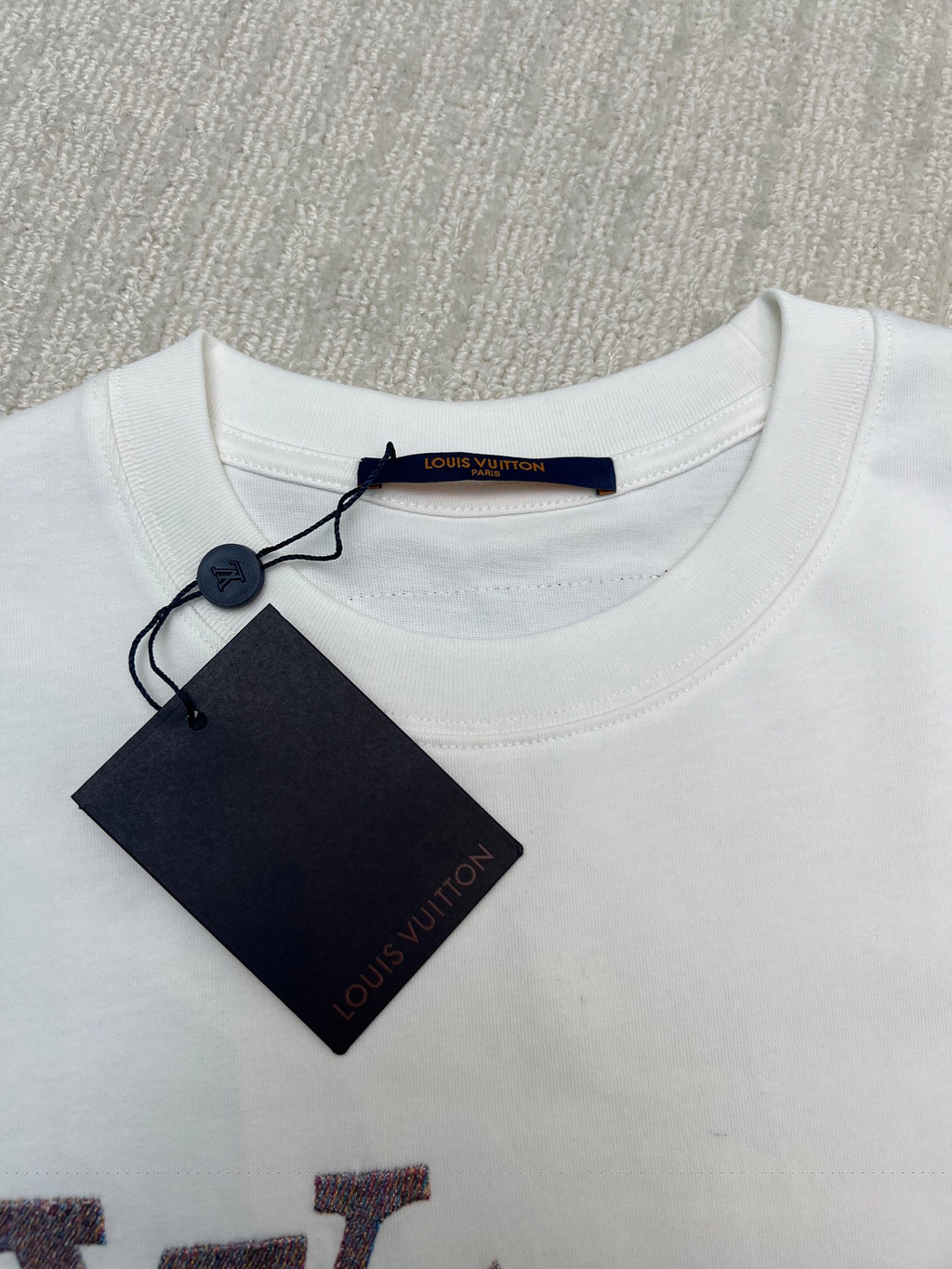 White Louis Vuitton T-shirt neckline with attached brand tag