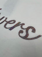 Close-up of multicolor LV logo embroidery on white T-shirt