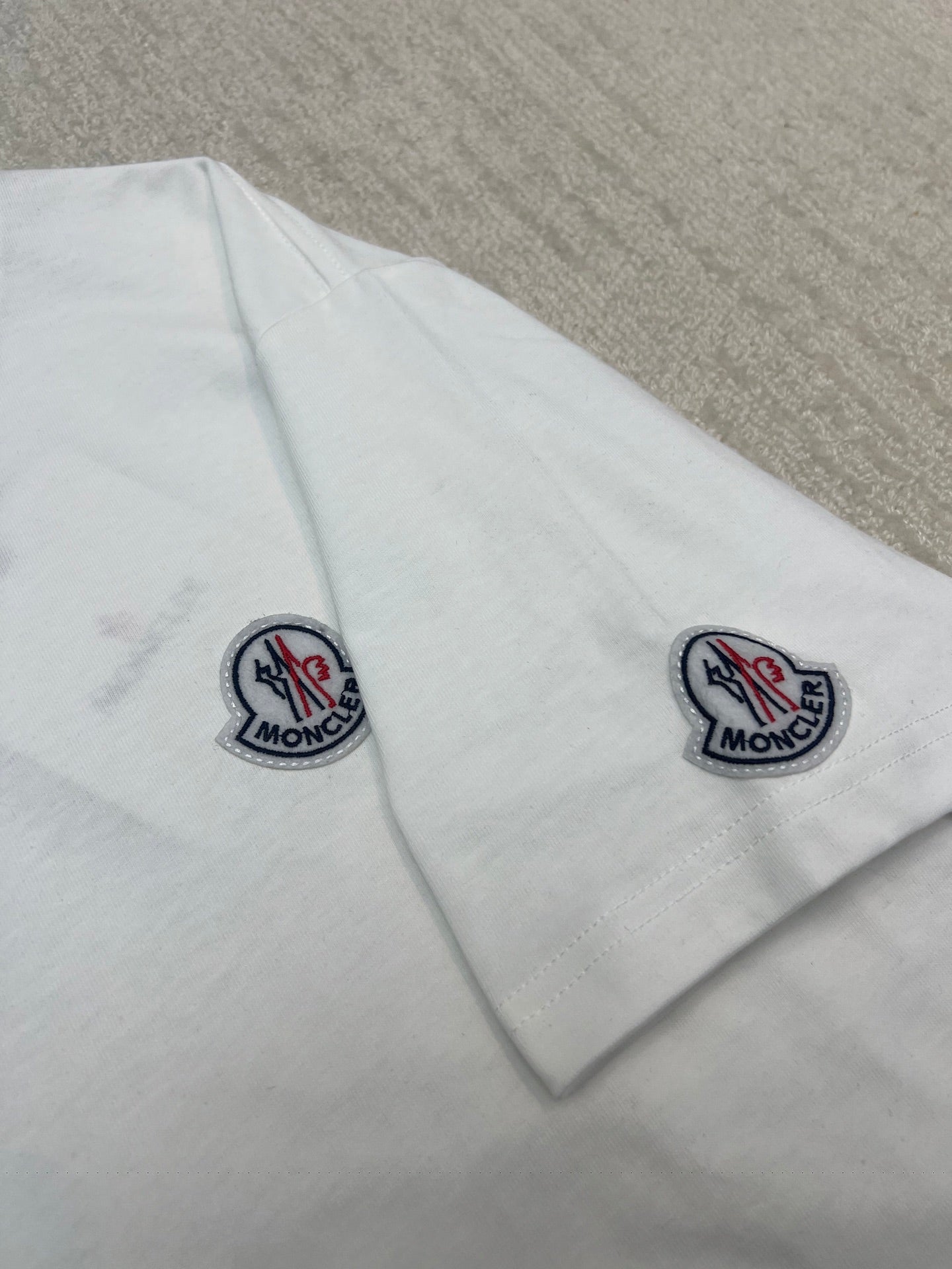 White Moncler T-shirt with logo patches on both sleeves, short sleeves