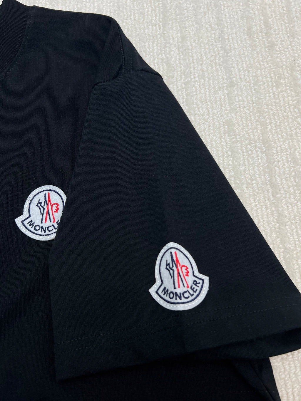 Black T-shirt with Moncler logo patches on sleeve and chest