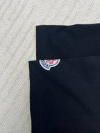 Back of black T-shirt with Moncler logo patch near collar