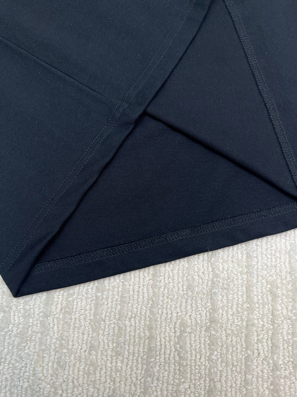 Black T-shirt hem with stitched seam detail