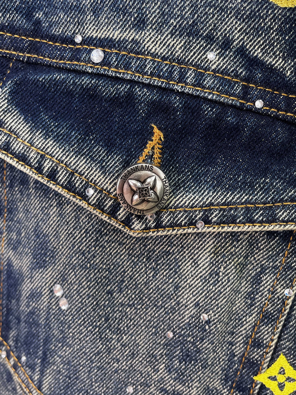 Denim jacket buttoned pocket with metal star emblem and contrast stitching