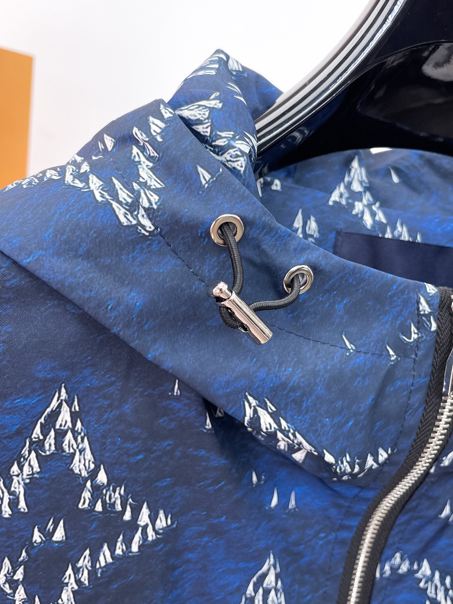 Long Louis Vuitton jacket in blue with white logo-like print and drawstring hood