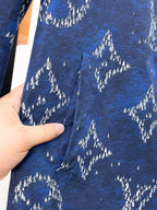 Blue patterned jacket fabric with white tree silhouettes