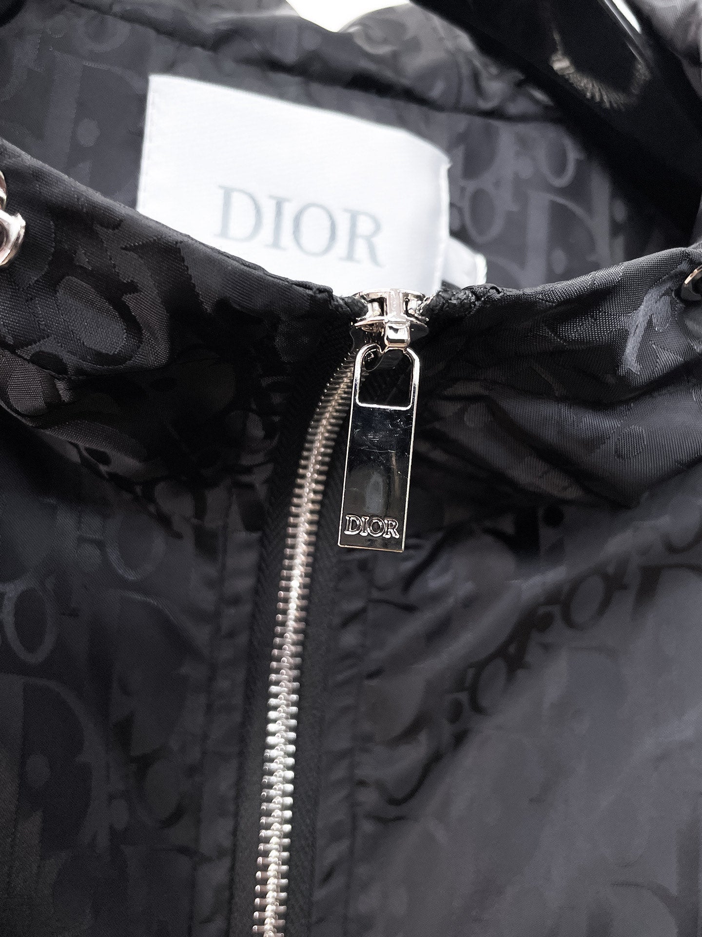Dior hooded jacket, close-up of silver zipper and Dior-branded pull