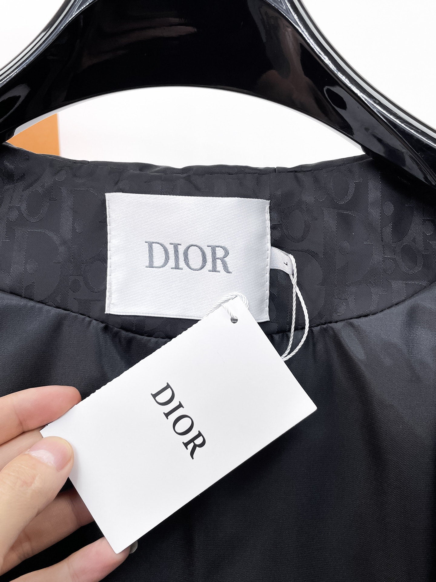 Dior hooded jacket lining, DIOR label and hanging tag at collar
