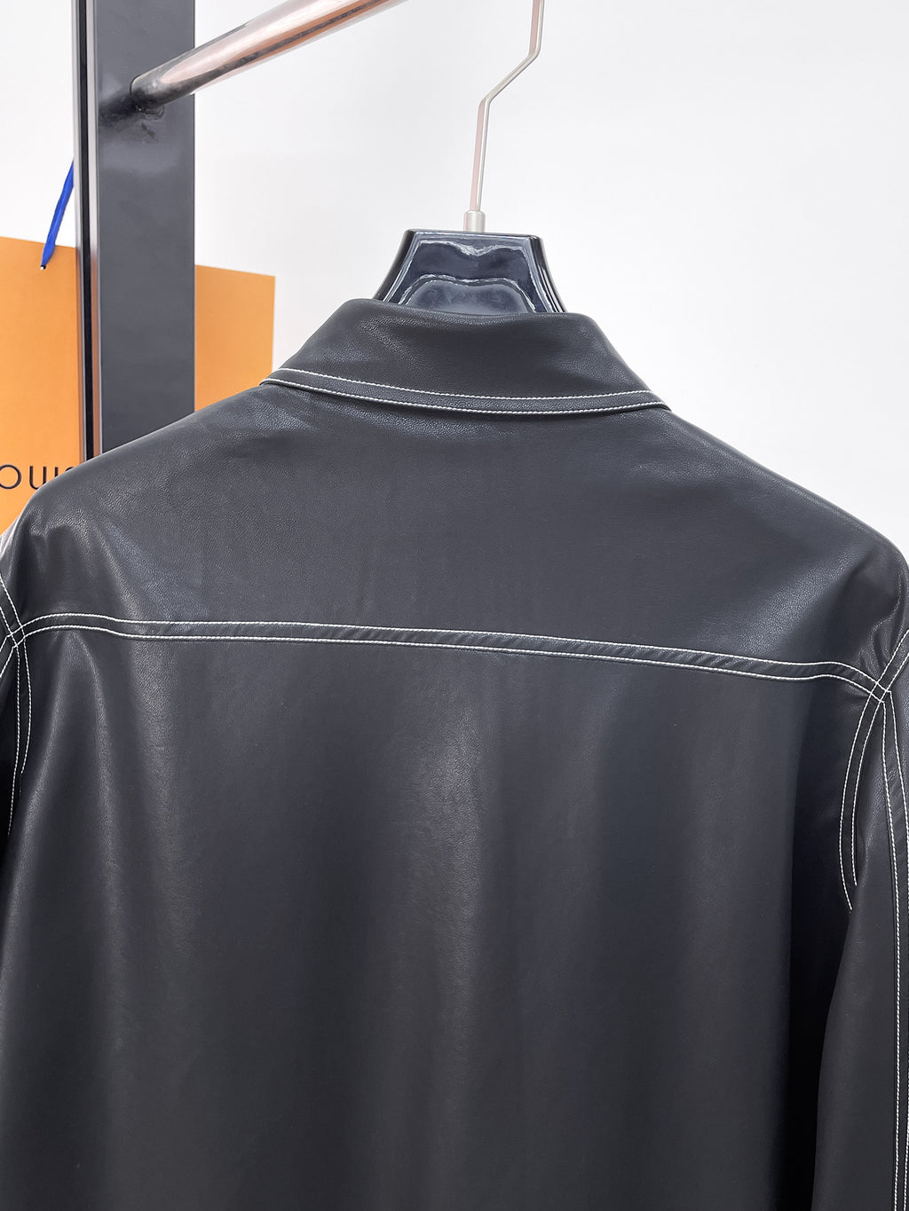 Prada long-sleeve shirt back view, dark with yoke seam and contrast stitching