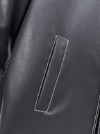 Black leather jacket front with vertical flap pocket and contrast piping