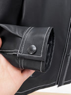 Black leather jacket cuff with contrast stitching and snap button
