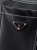 Prada logo patch on black leather chest pocket with contrast stitching