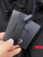 Long coat neck with PRADA hanging tag and drawstring loop