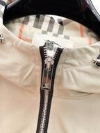 Beige jacket lining with check pattern and silver zipper pull on front