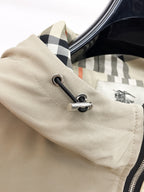 Beige hood jacket cuff detail with black cord and check lining