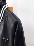 Prada black leather jacket with striped ribbed collar and metal logo plaque