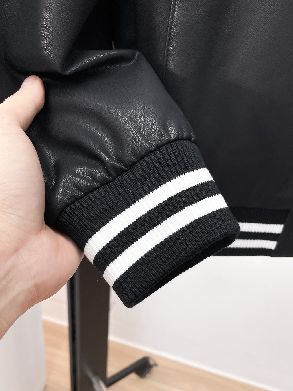 Prada leather jacket cuff with black ribbed knit and two white stripe bands