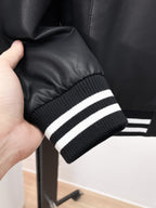 Prada leather jacket cuff with black ribbed knit and two white stripe bands