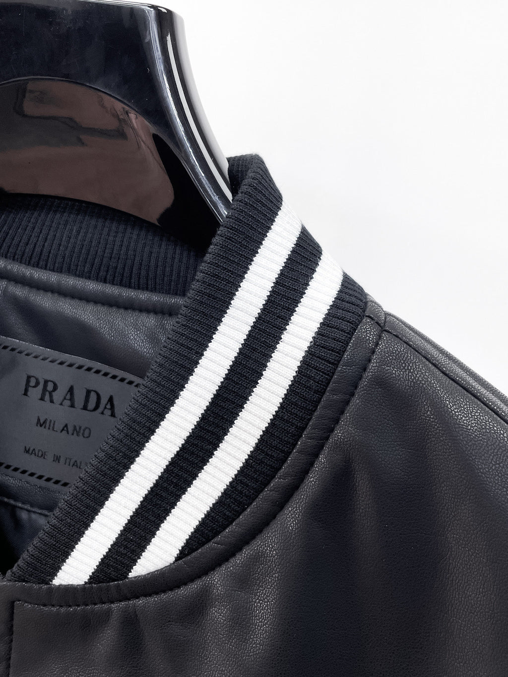Black leather jacket collar with white and dark blue striped ribbed trim