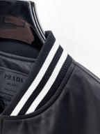 Black leather jacket collar with white and dark blue striped ribbed trim