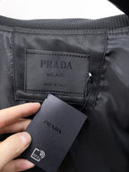 Prada Milano tag and RFID tag inside black leather jacket
