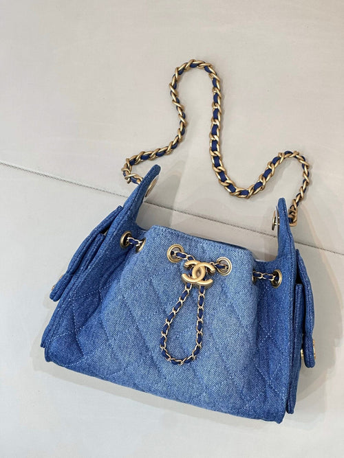 Chanel blue denim handbag with chain strap, gold logo clasp and dangling charm