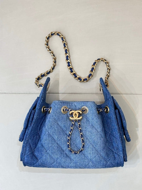 Chanel blue denim handbag with chain strap, gold hardware and front charm