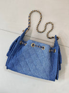 Chanel blue denim handbag with chain straps and quilted pattern, gold logo