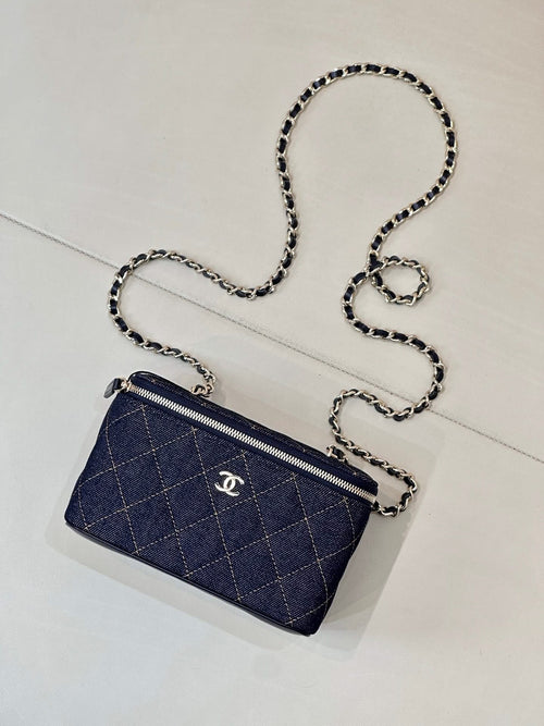 Chanel mini quilted bag, dark blue, with chain strap, zipper top, and CC logo