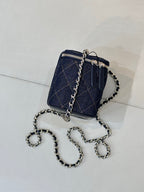 Chanel mini quilted bag in dark blue with chain strap and zipper, side view