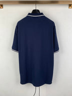 Navy polo shirt back view with white-trimmed collar and short sleeves