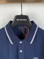 Navy polo shirt with button placket and Prada Milano logo at chest