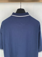 Navy polo shirt neckline with white double-stripe collar trim