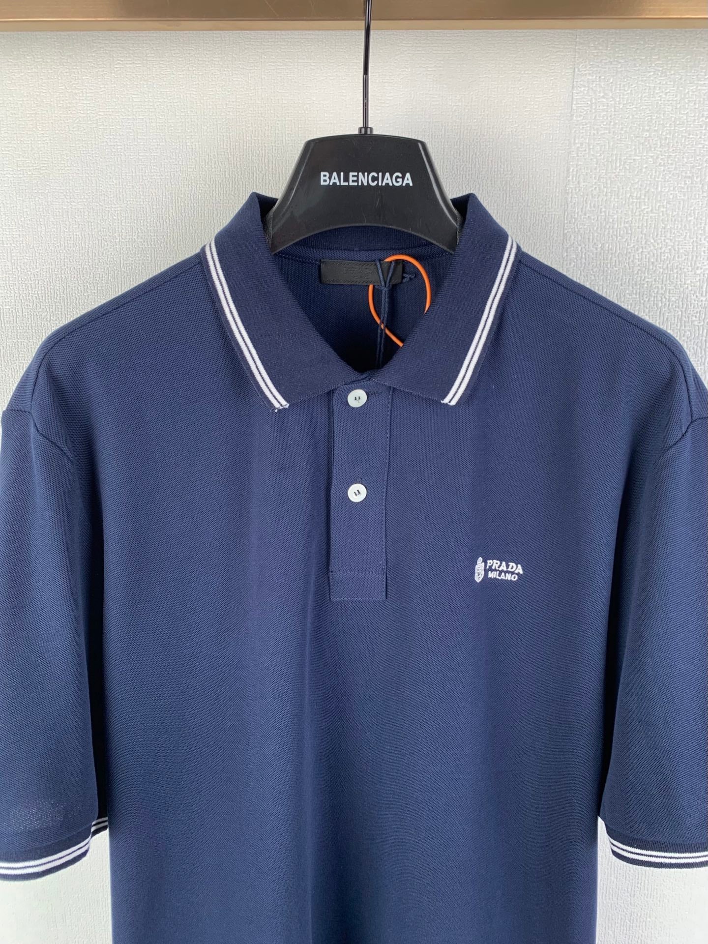 Navy polo shirt with button placket and Prada Milano chest logo, white trim