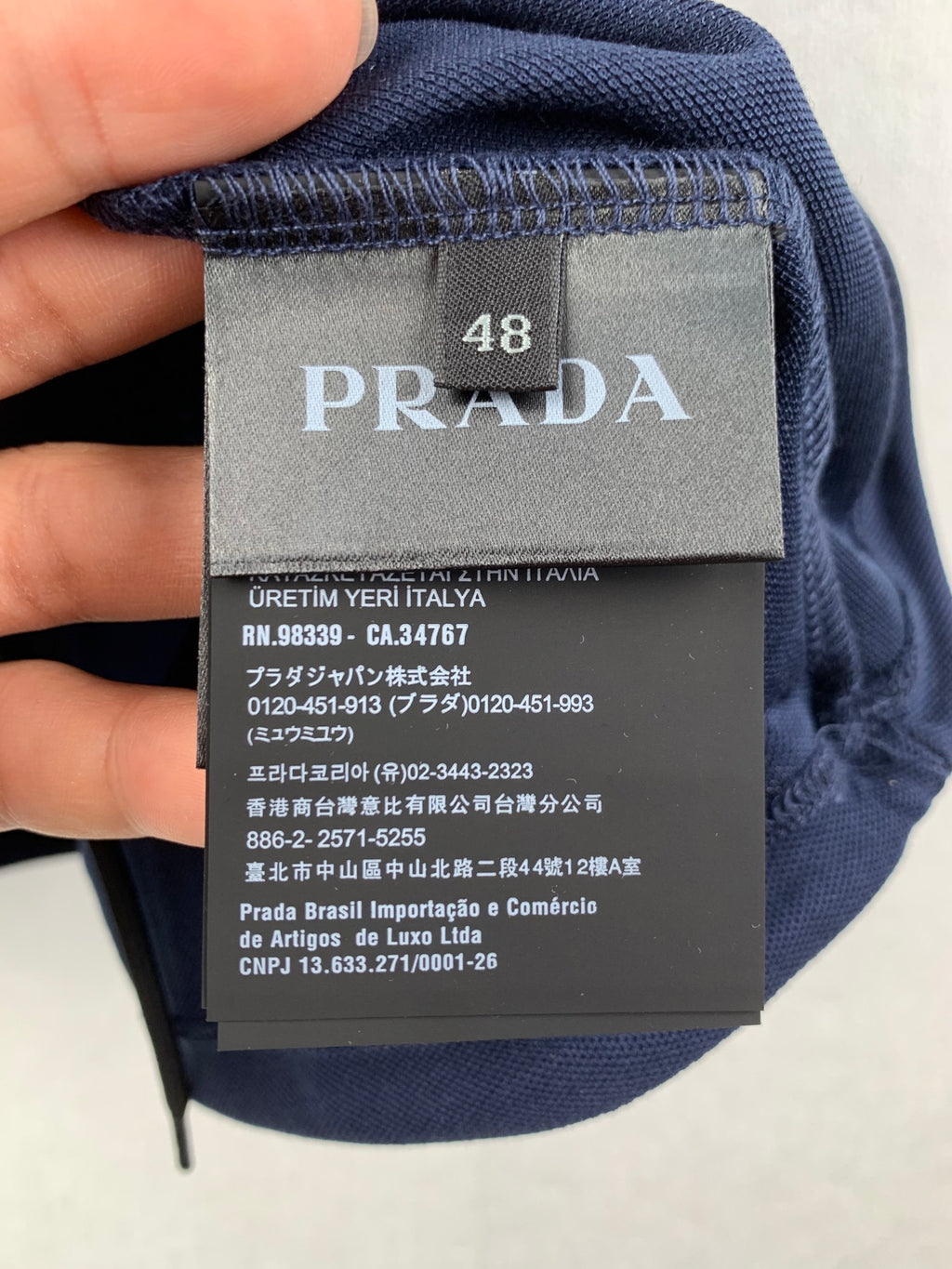 Prada size and fabric label on navy polo shirt, size 48