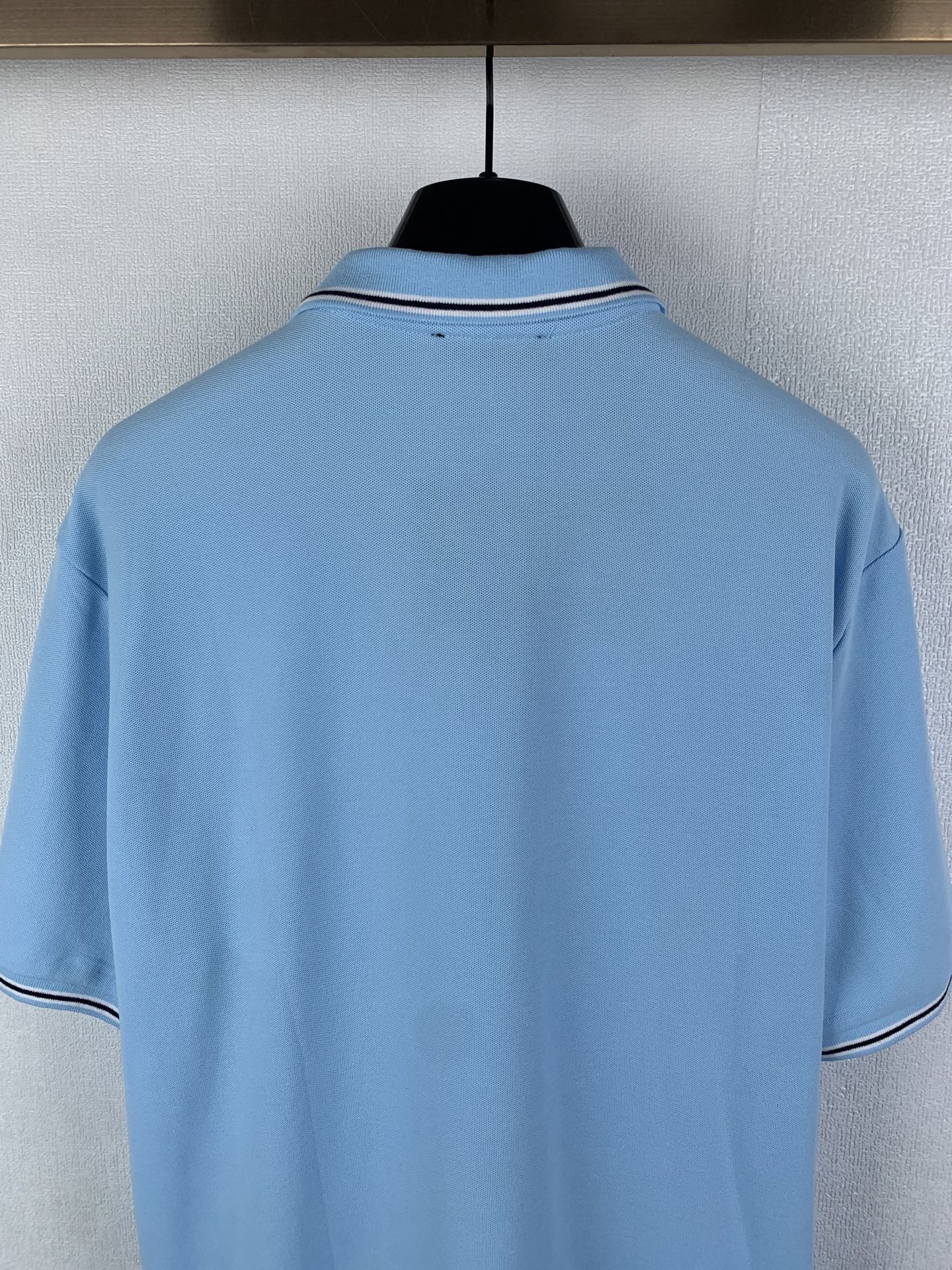 Light blue polo shirt back with white-trim collar and short sleeves