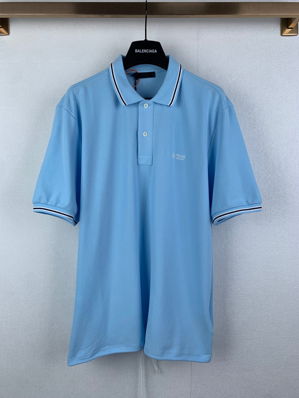 Light blue polo shirt with white-trim collar and short sleeves