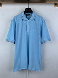 Light blue polo shirt with white-trim collar and short sleeves