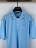 Light blue polo shirt with white-trim collar, button placket, and chest logo