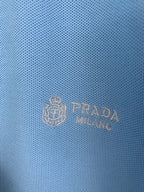Light blue polo fabric with embossed Prada logo crest